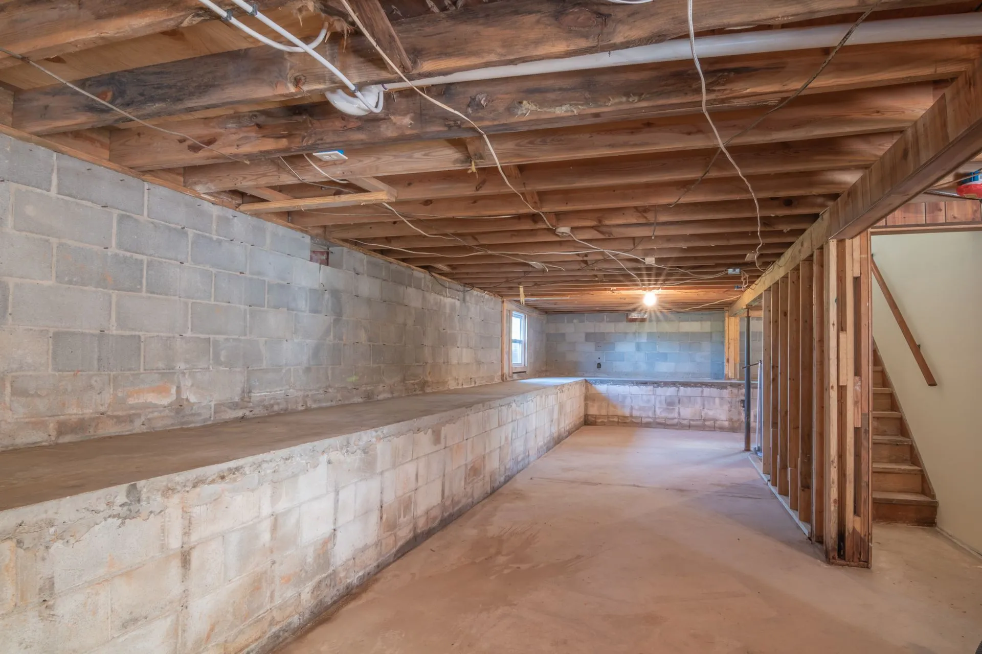 Unfinished basement with concrete block walls and a concrete floor, where radon enters most homes