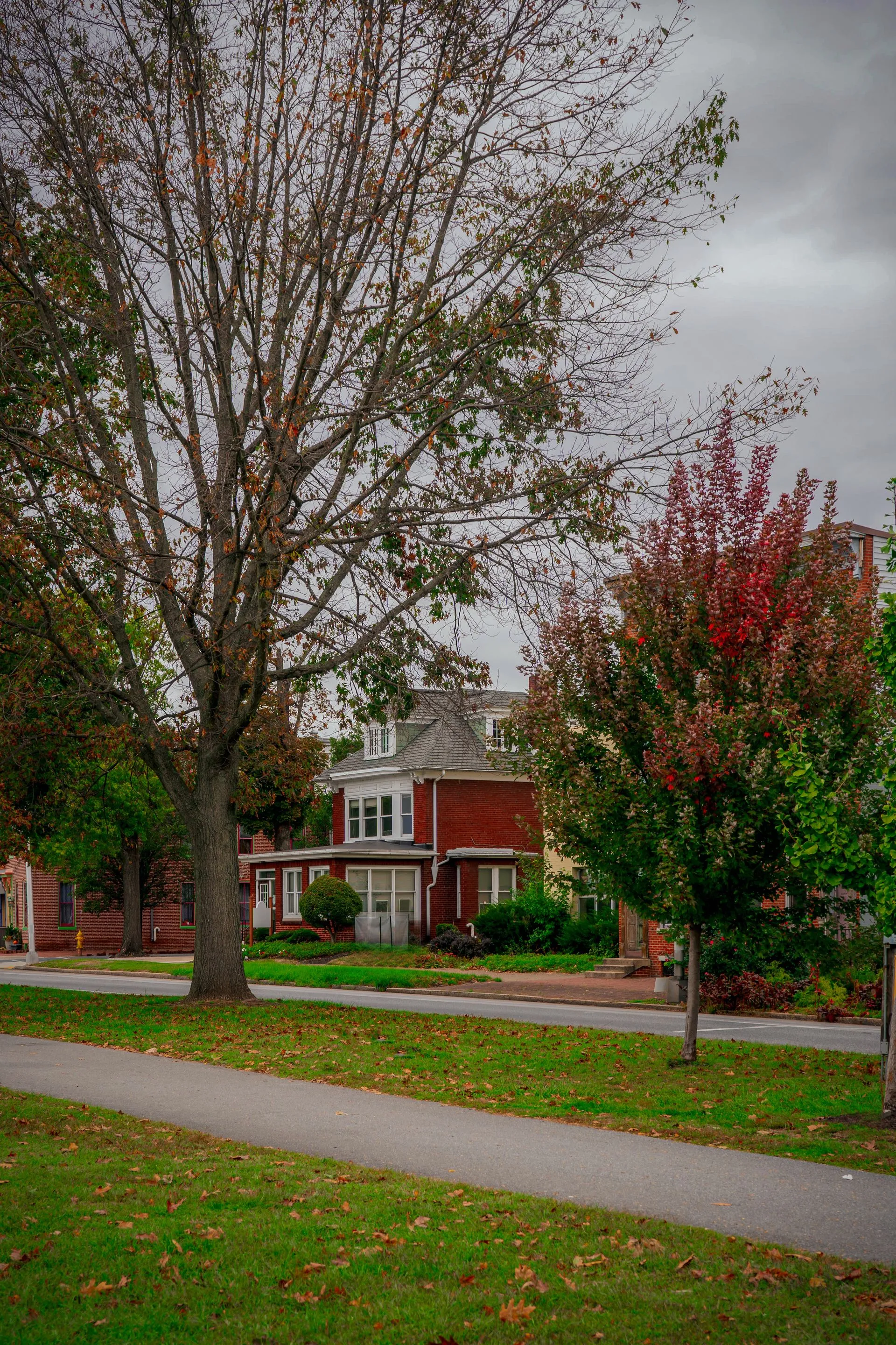 Brick home in central Pennsylvania surrounded by autumn trees