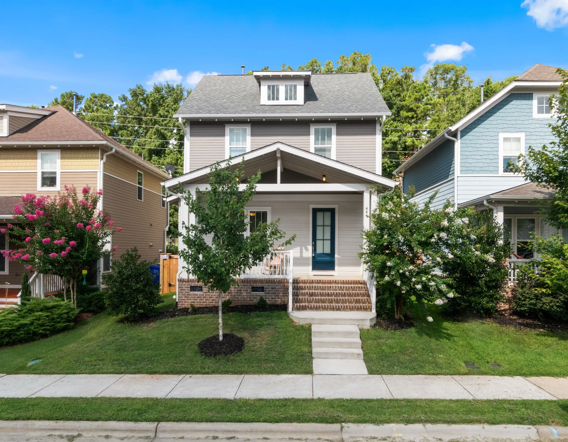 Radon mitigation York PA: two-story home with a front porch and basement windows