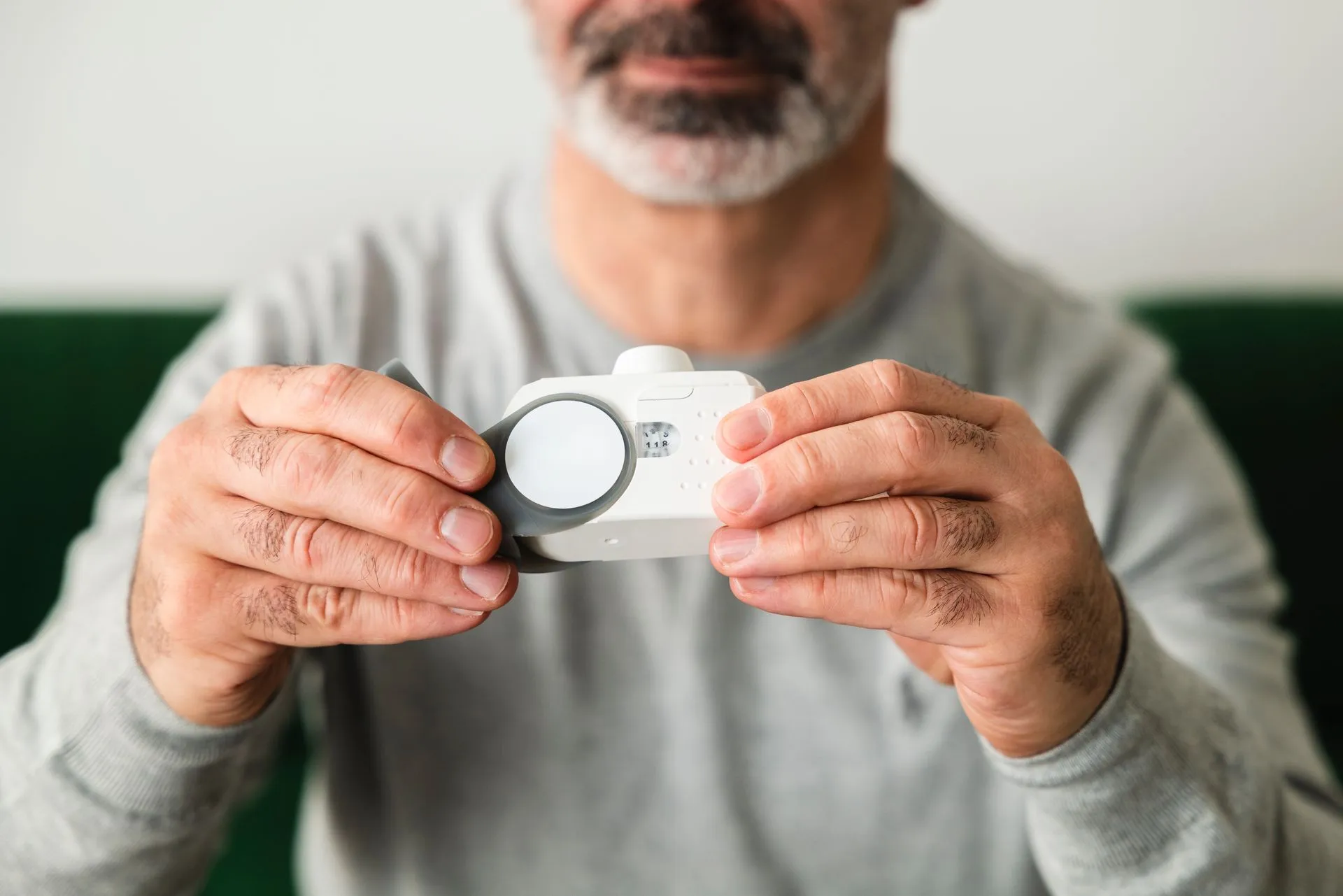 Person holding a digital indoor air monitor
